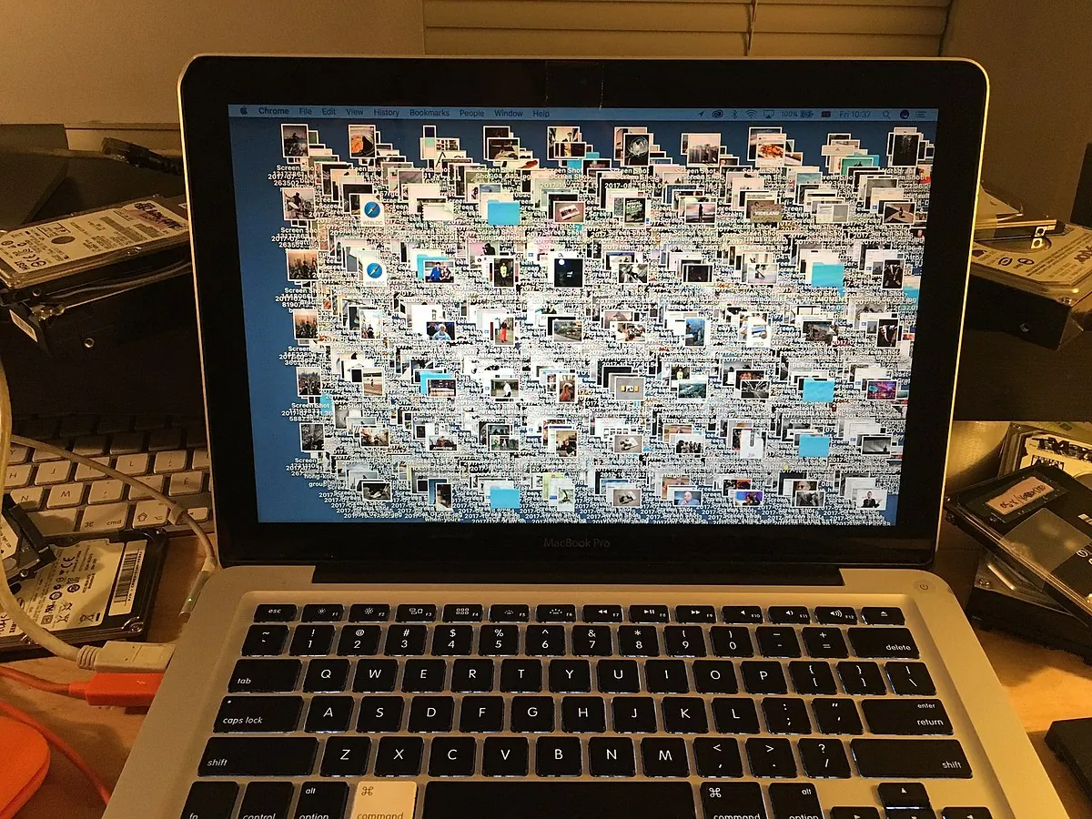 A MacBook desktop buried under hundreds of files